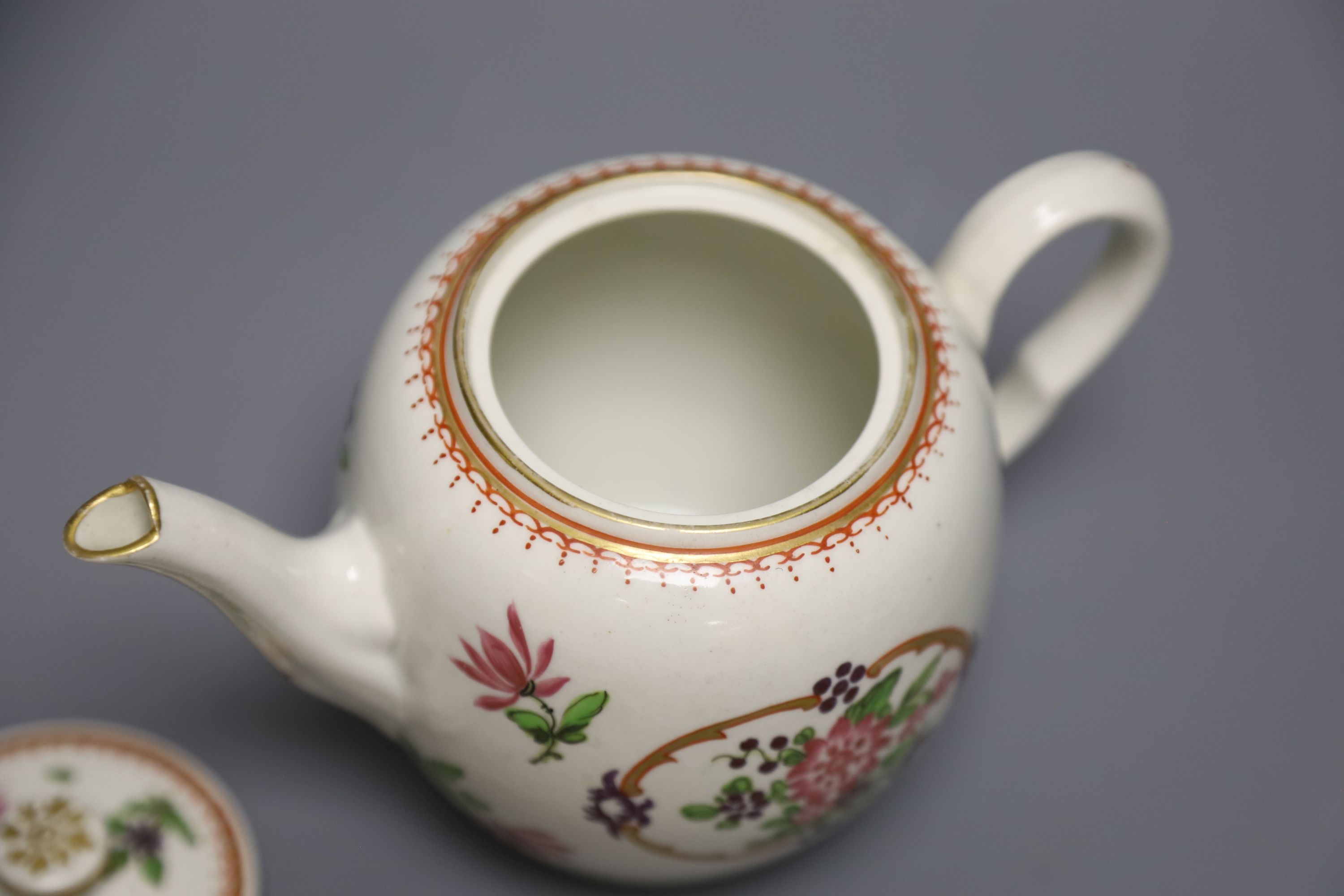 An 18th century Worcester fine teapot and cover of Companie des Indes type painted with Chinese flowers, height 12cm